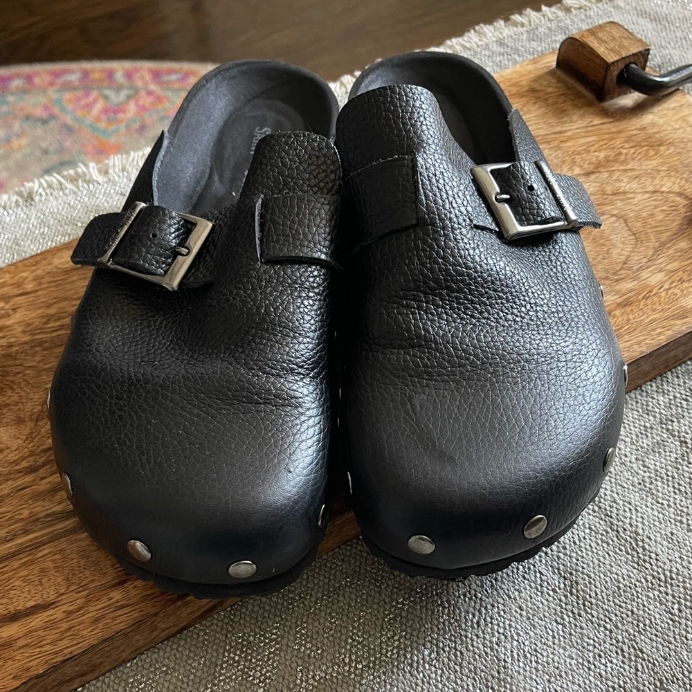 Black leather studded clogs
